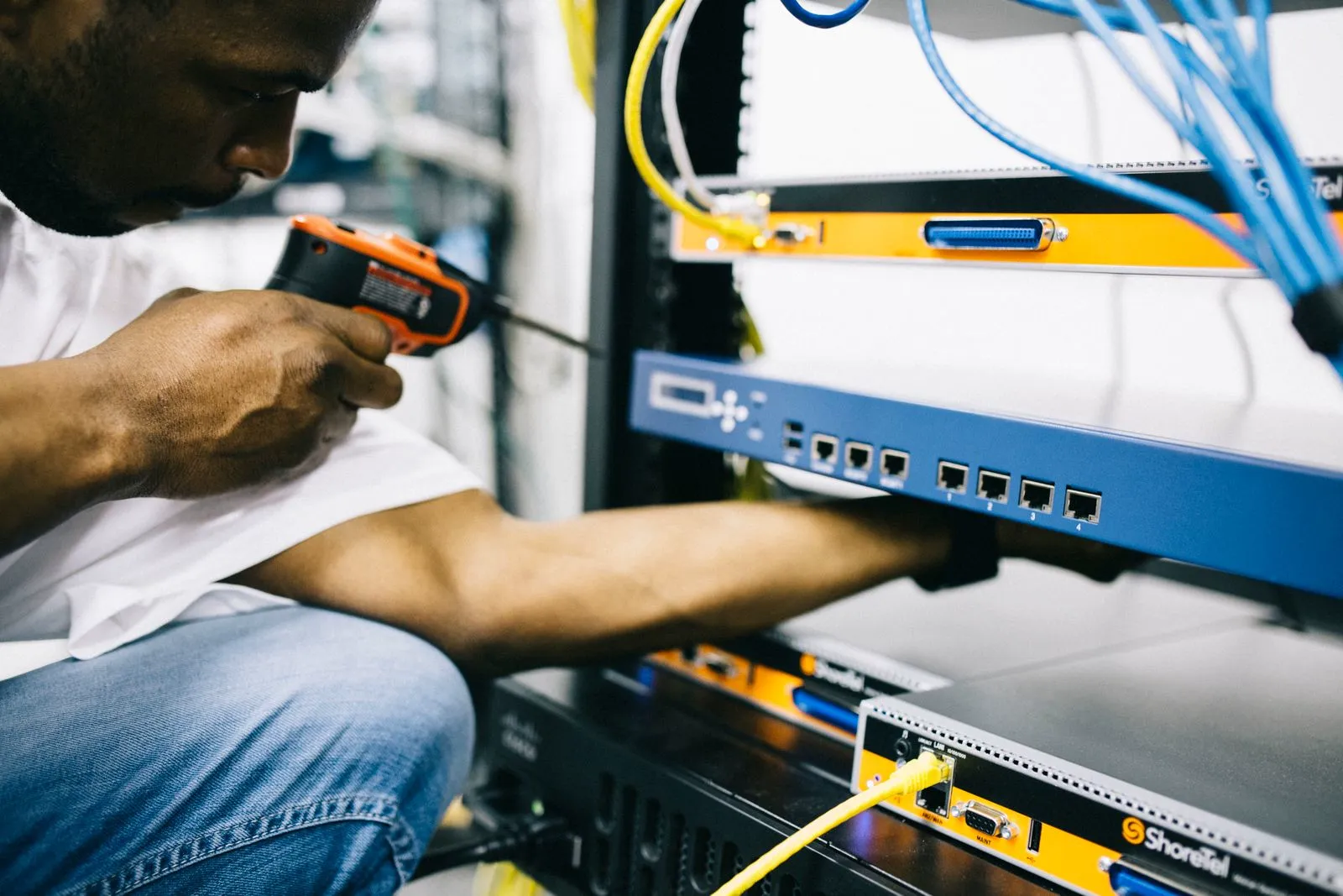 Technician handling network cabling during connectivity work