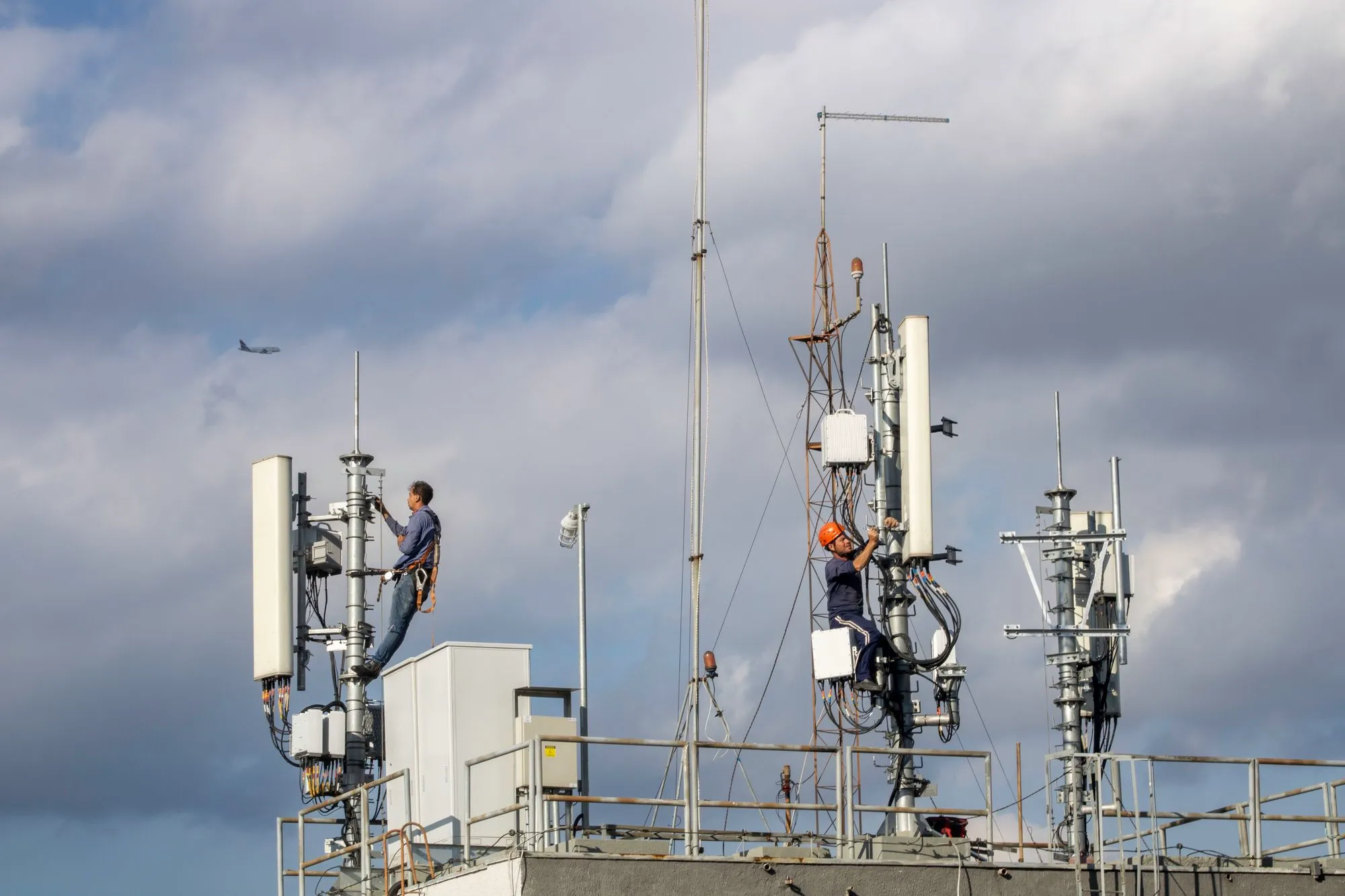 Telecom technicians maintaining cellular network equipment